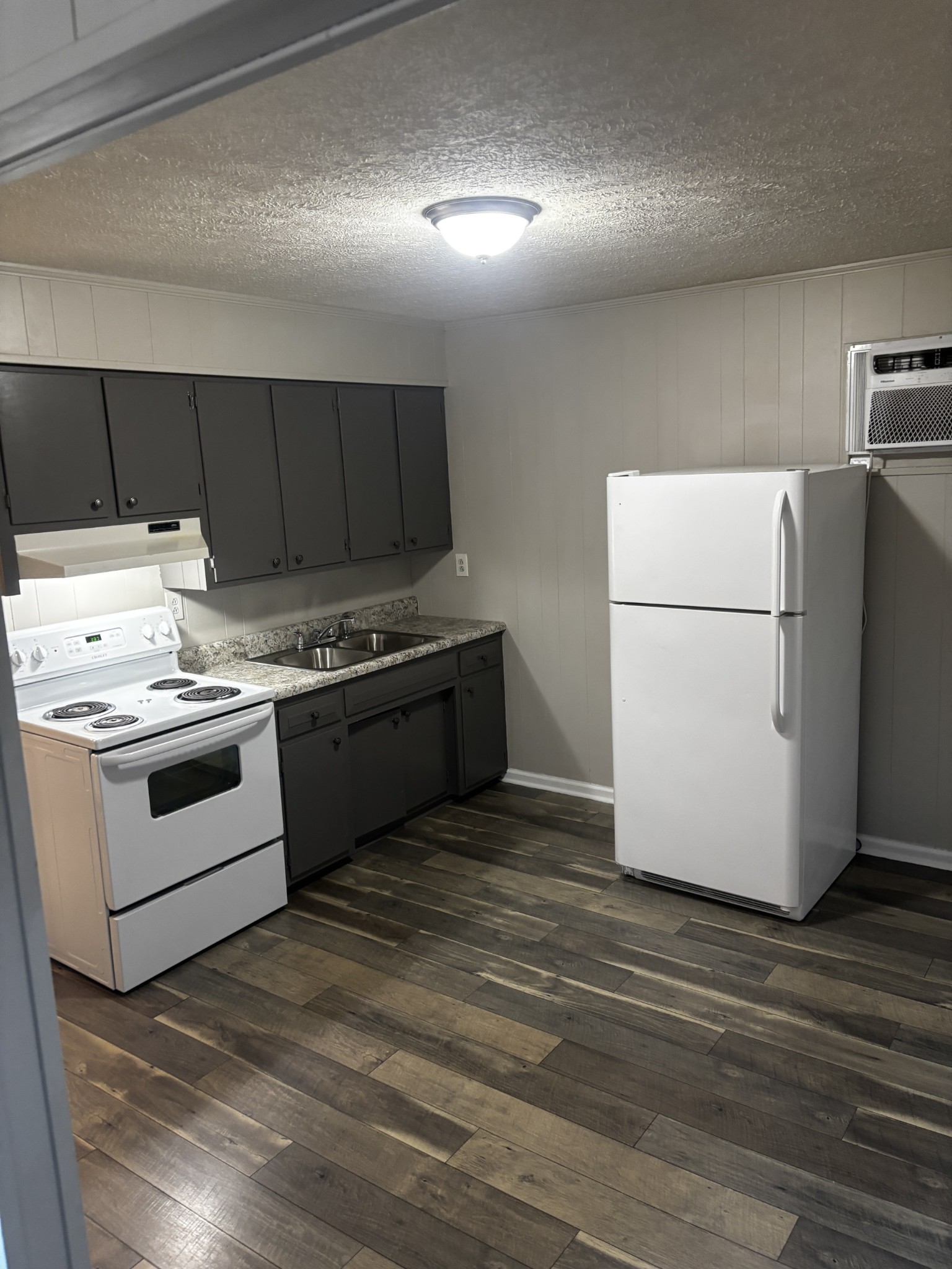 1326 Spring Street, Unit 10 Dover, TN 37058 - Photo 3 of 9 a kitchen with a stove a refrigerator and a sink