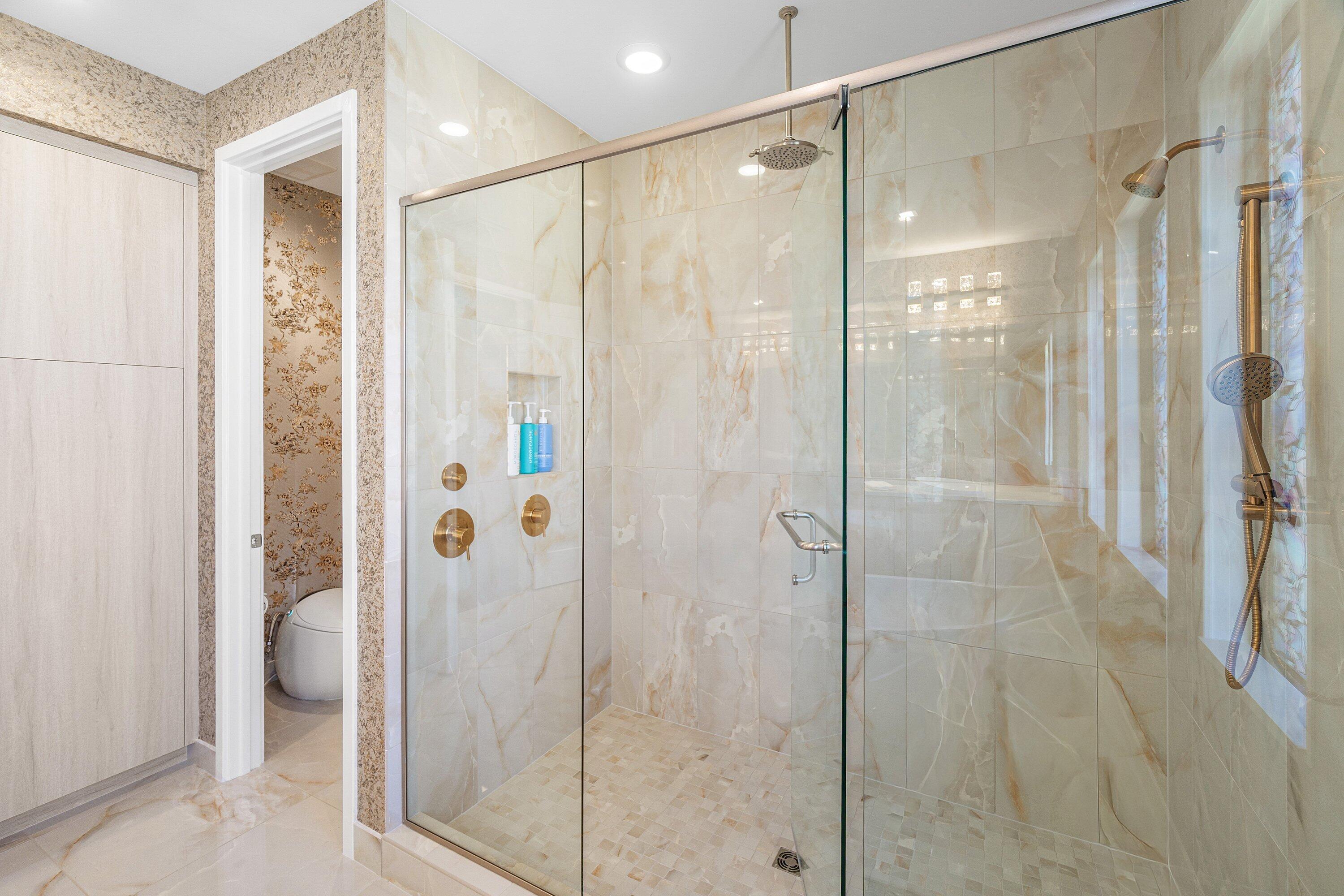8233 Crystal Downs Avenue Boca Raton, FL 33434 - Photo 38 of 58 a bathroom with a glass shower door
