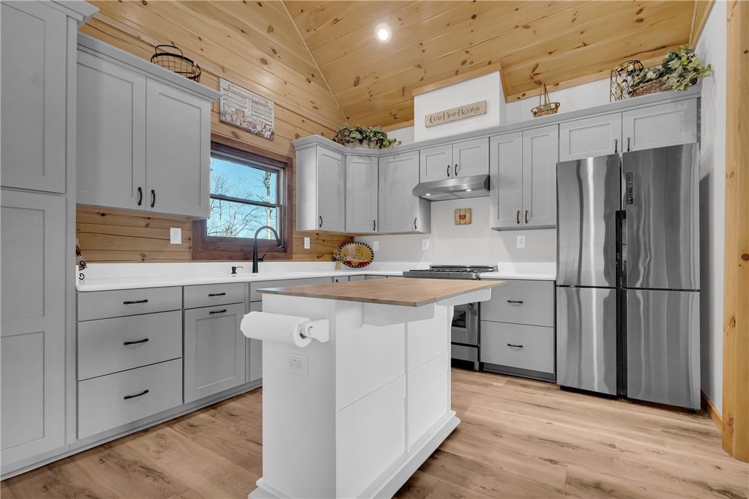 239 North Little River Road Salem, SC 29676 - Photo 16 of 43 This modern kitchen features a spacious island and ample cabinetry, offering a seamless blend of style and functionality.