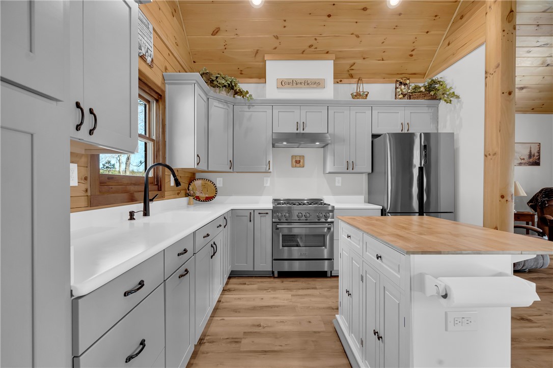239 North Little River Road Salem, SC 29676 - Photo 17 of 43 This bright kitchen features wood flooring, a central island, and modern stainless steel appliances.