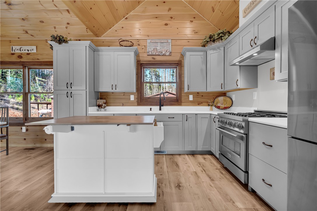239 North Little River Road Salem, SC 29676 - Photo 18 of 43 This spacious kitchen offers a blend of natural wood accents and modern amenities.