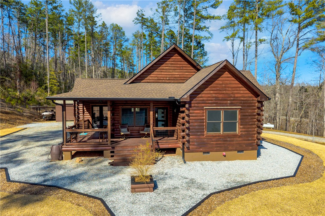 239 North Little River Road Salem, SC 29676 - Photo 2 of 43 This charming wooden home is nestled among a vibrant forest, offering serene views.