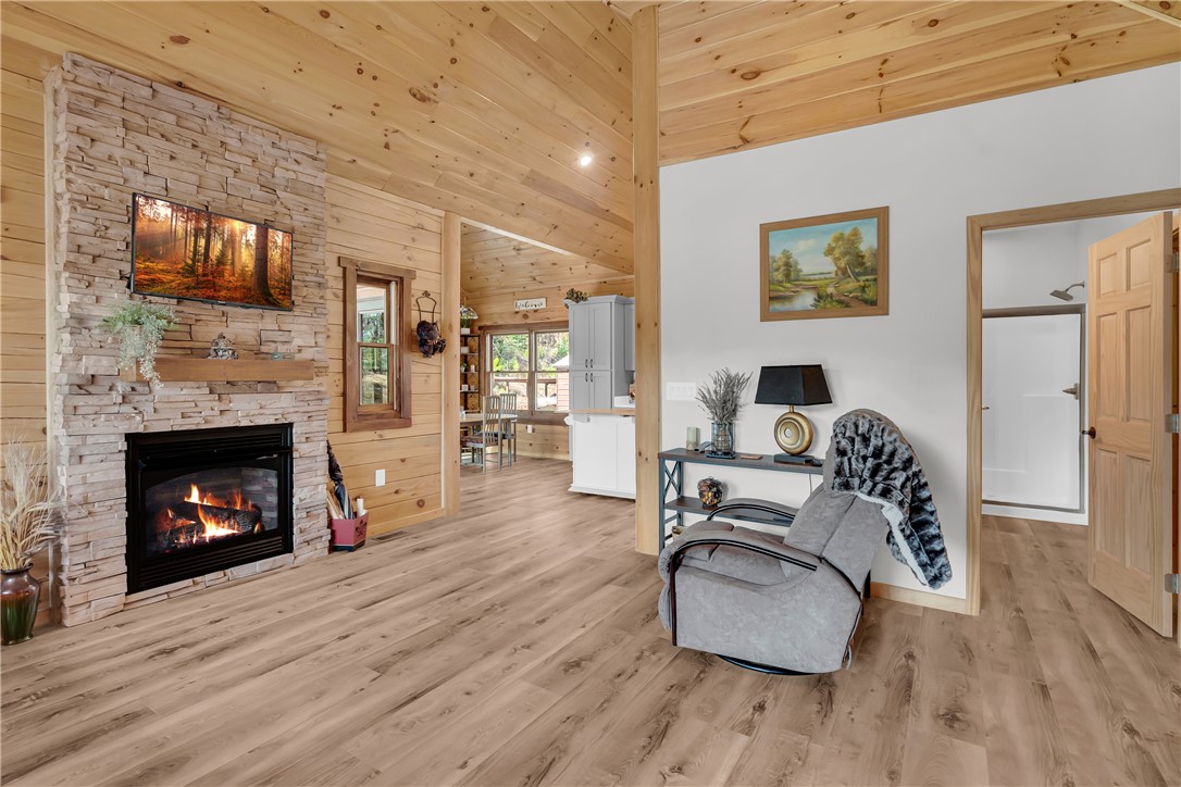 239 North Little River Road Salem, SC 29676 - Photo 21 of 43 This living area features a warm fireplace and soaring vaulted ceilings, perfect for cozy gatherings.