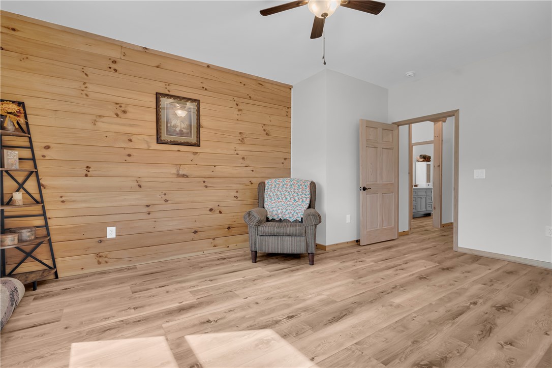 239 North Little River Road Salem, SC 29676 - Photo 28 of 43 This bright bedroom features warm wood paneling and elegant flooring, creating a comfortable living space.