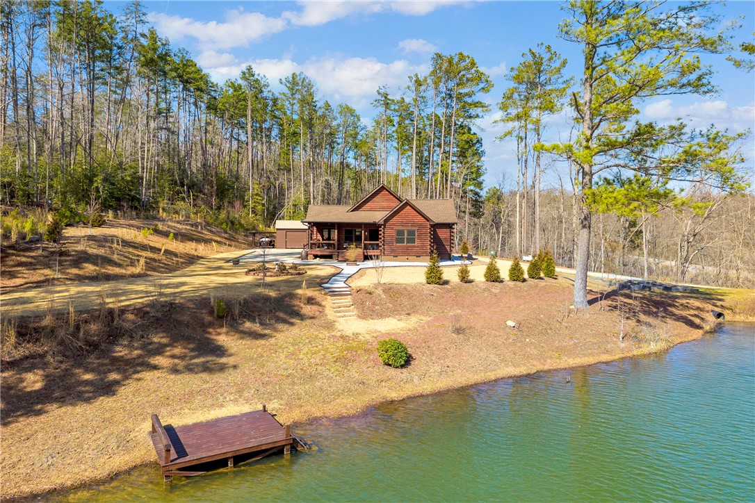 239 North Little River Road Salem, SC 29676 - Photo 3 of 43 This secluded lakefront cabin offers serene living amidst a beautiful wooded landscape.