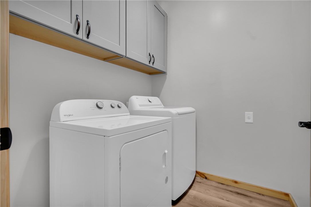 239 North Little River Road Salem, SC 29676 - Photo 32 of 43 Functional laundry room featuring a washer and dryer with convenient upper cabinetry.