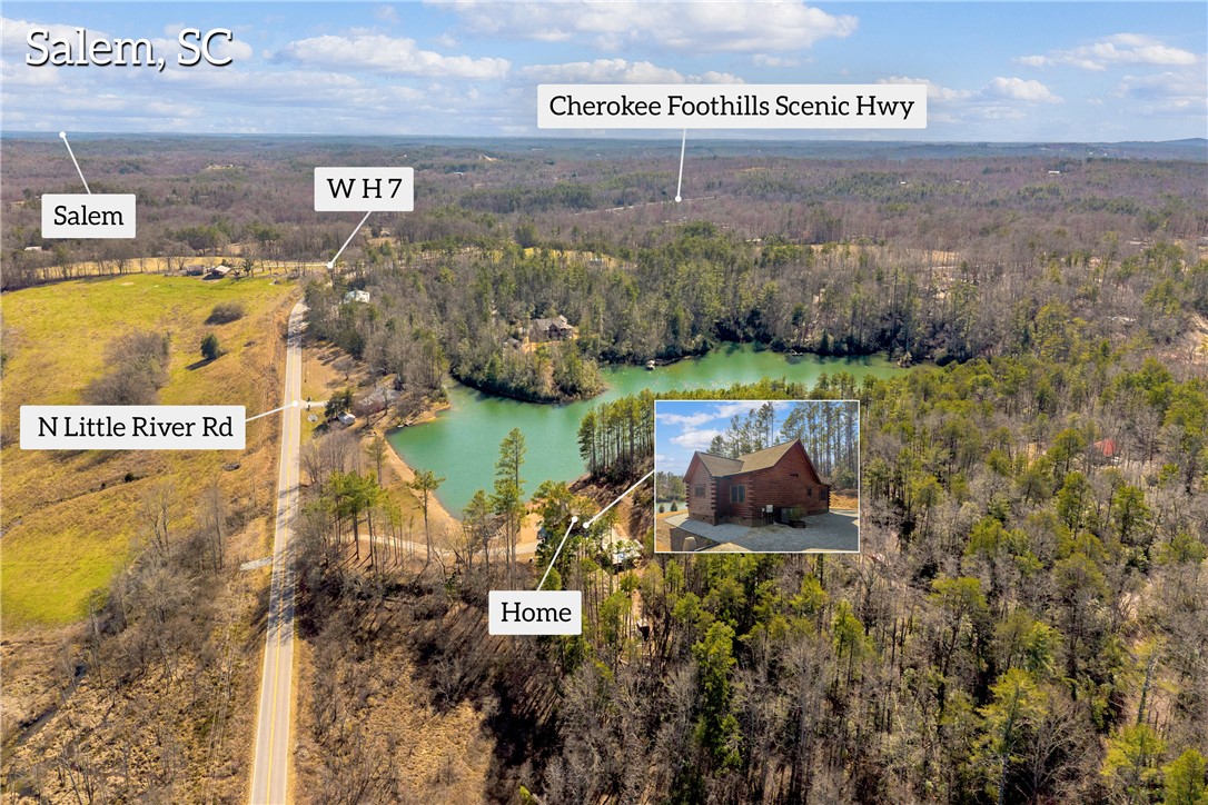 239 North Little River Road Salem, SC 29676 - Photo 36 of 43 An aerial view captures a serene landscape with a tranquil body of water and lush woodlands.