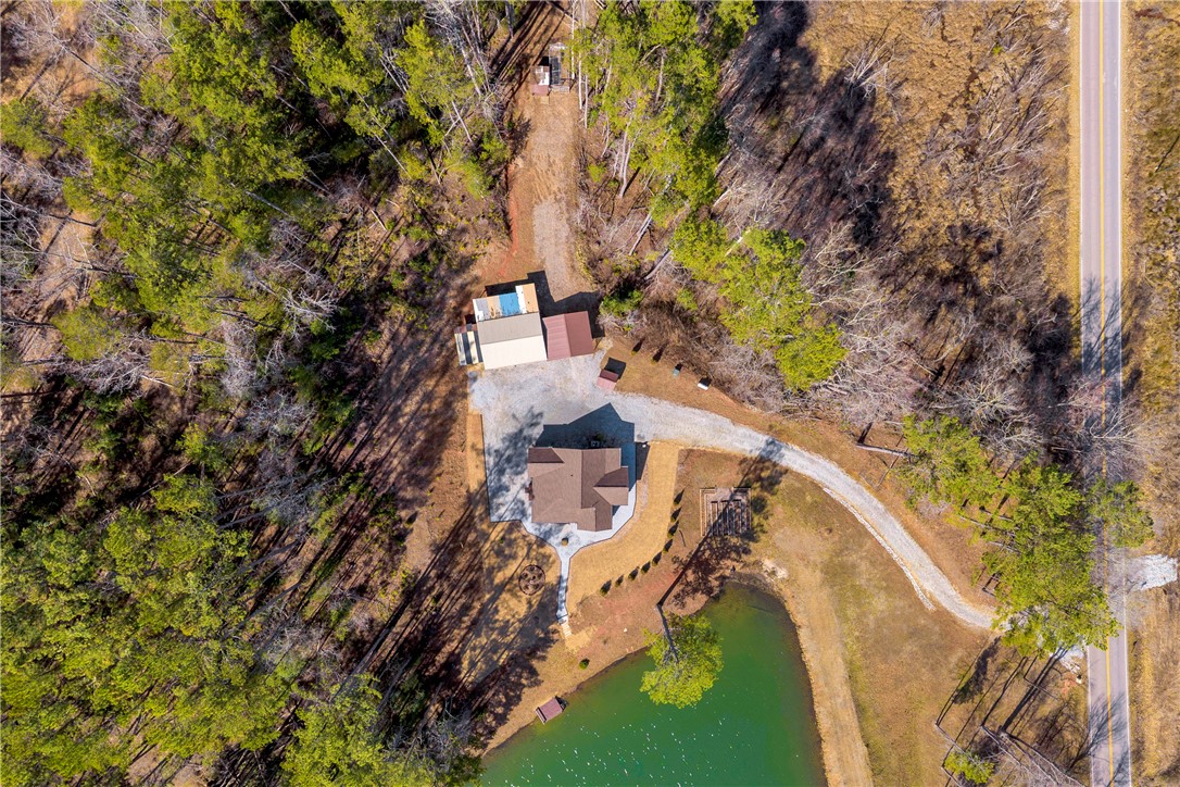239 North Little River Road Salem, SC 29676 - Photo 40 of 43 An aerial perspective reveals a charming residence nestled beside a tranquil pond and winding drive.