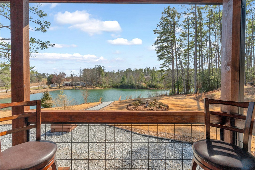 239 North Little River Road Salem, SC 29676 - Photo 5 of 43 Enjoy tranquil water views from this inviting outdoor living space.
