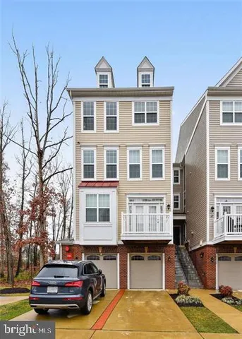 a front view of residential houses with yard