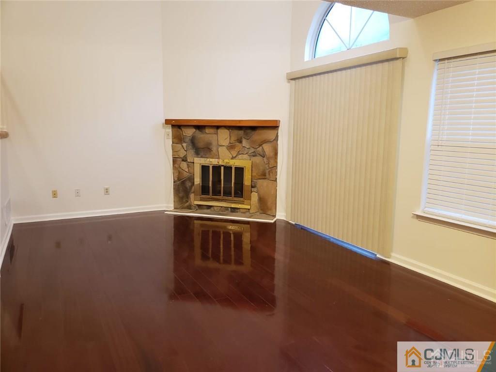210 Nebula Road Piscataway, NJ 08854 - Photo 3 of 25 a view of an empty room with wooden floor and a window