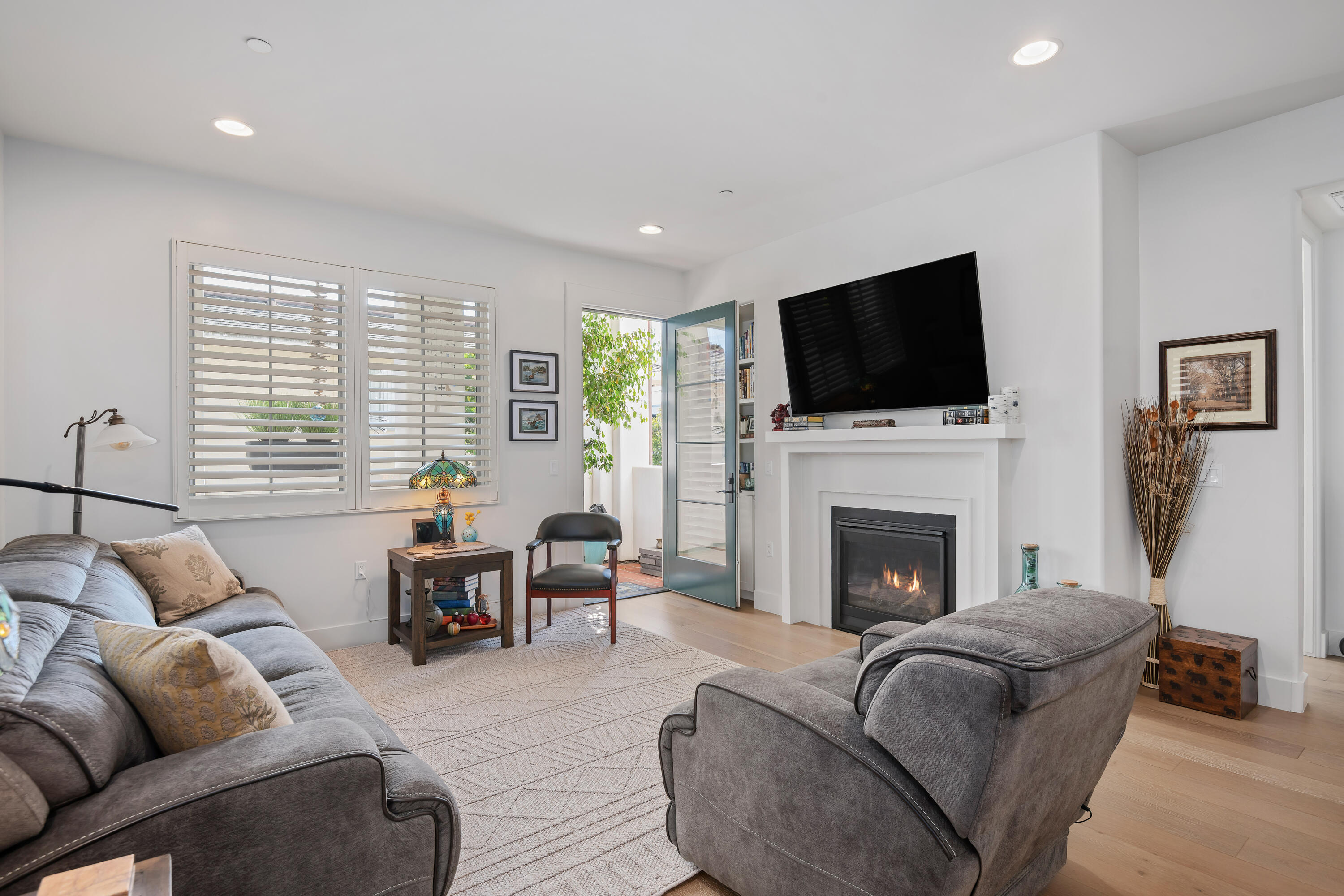 3726 State Street, Unit 203 Santa Barbara, CA 93105 - Photo 2 of 30 a living room with furniture a flat screen tv and a fireplace