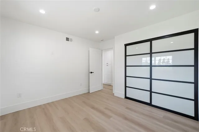 a view of wooden floor and windows in a room