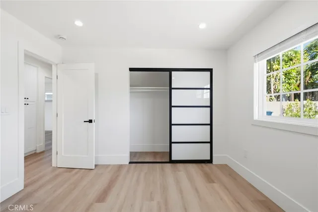 an empty room with windows and closet