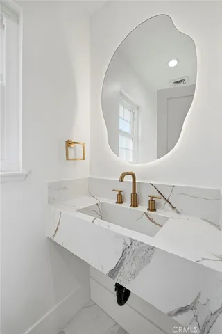 a bathroom with a sink and a mirror