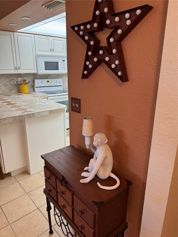 23465 Harbor View Road, Unit 244 Punta Gorda, FL 33980 - Photo 23 of 61 a kitchen with a sink a stove and cabinets