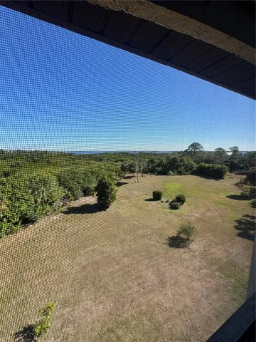 a living room with furniture and a dining table