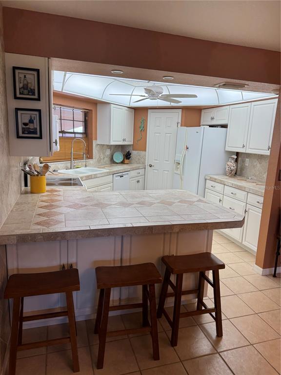 23465 Harbor View Road, Unit 244 Punta Gorda, FL 33980 - Photo 4 of 61 a kitchen with a table and chairs in it