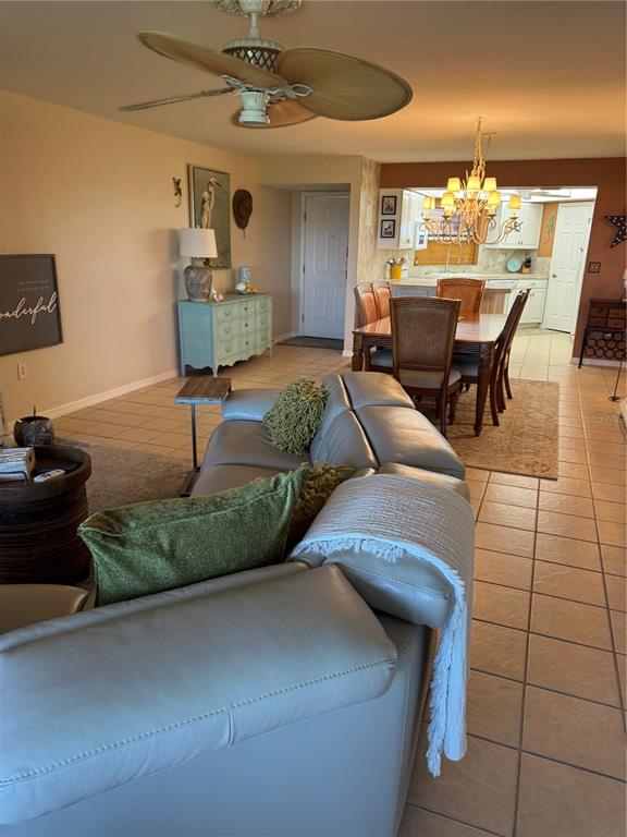 23465 Harbor View Road, Unit 244 Punta Gorda, FL 33980 - Photo 41 of 61 a living room with furniture and a chandelier