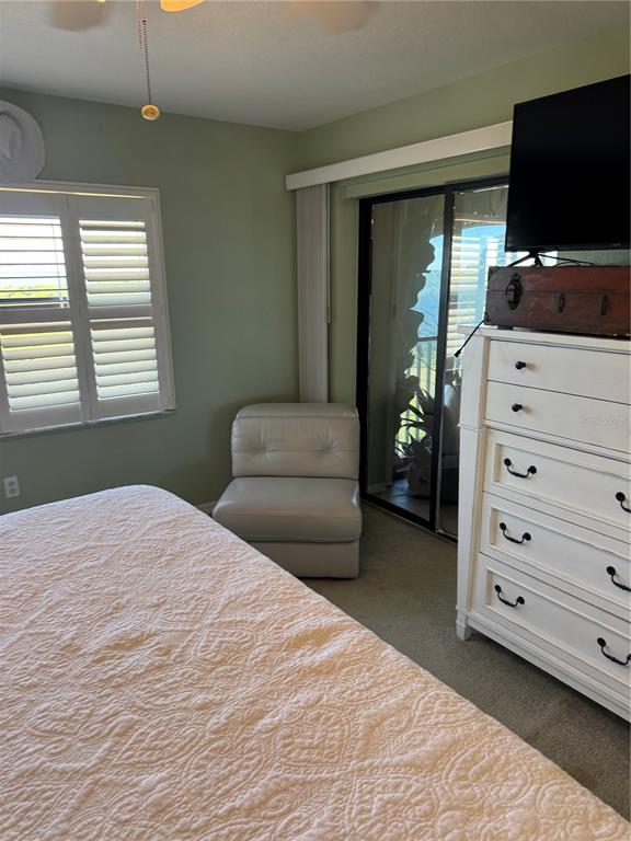 23465 Harbor View Road, Unit 244 Punta Gorda, FL 33980 - Photo 46 of 61 a bedroom with a bed and flat screen tv