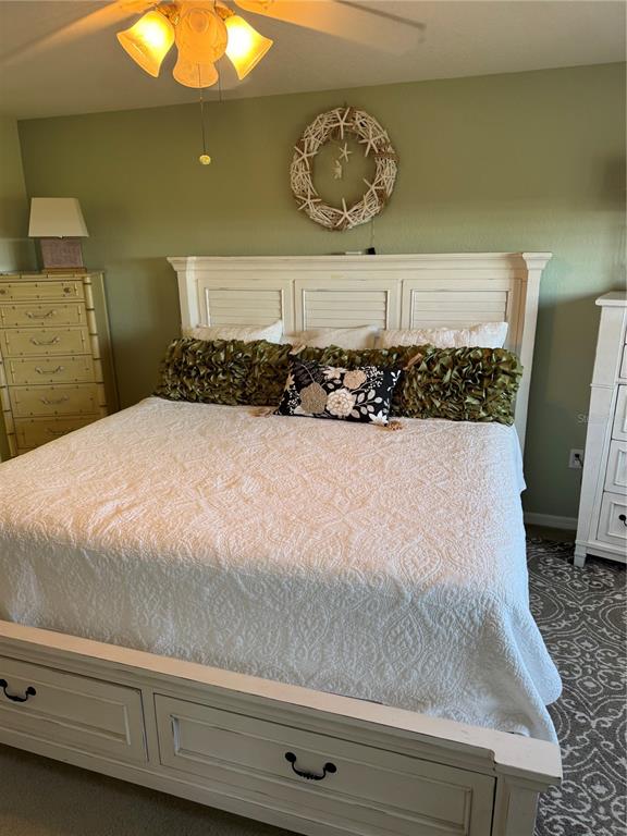 23465 Harbor View Road, Unit 244 Punta Gorda, FL 33980 - Photo 49 of 61 a bedroom with a bed and a chandelier