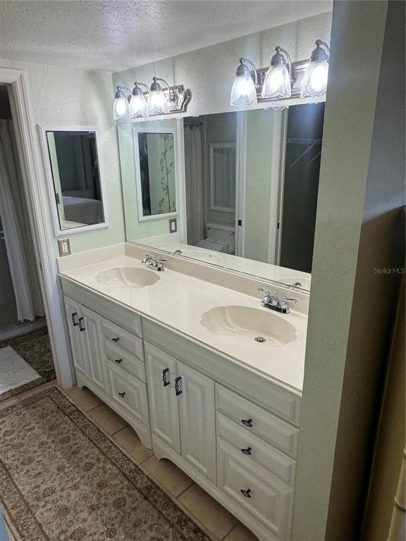 23465 Harbor View Road, Unit 244 Punta Gorda, FL 33980 - Photo 54 of 61 a spacious bathroom with double sink and mirror