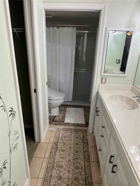 23465 Harbor View Road, Unit 244 Punta Gorda, FL 33980 - Photo 55 of 61 a bathroom with a sink a toilet and a mirror