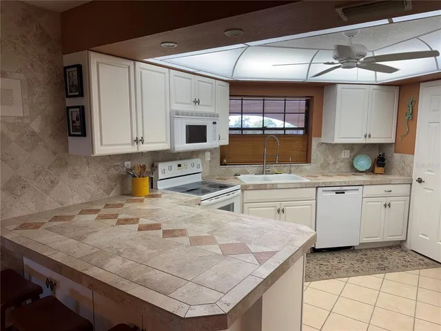 a kitchen with stainless steel appliances a refrigerator sink and cabinets