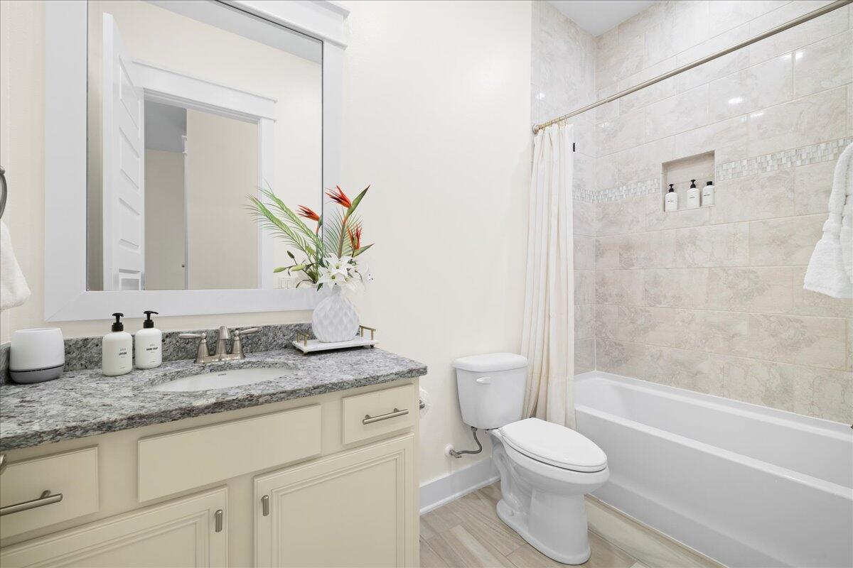 73 Dune Comet Lane, Unit B Inlet Beach, FL 32461 - Photo 12 of 25 a bathroom with a granite countertop sink a toilet and shower