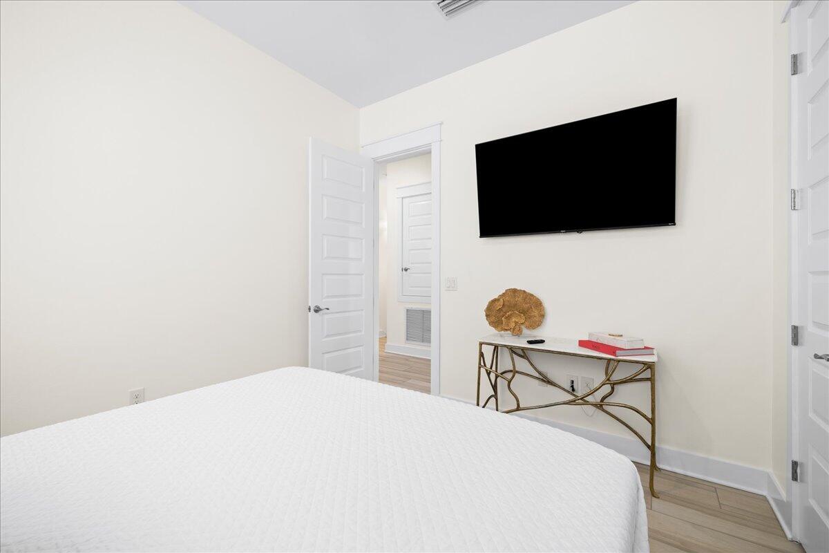 73 Dune Comet Lane, Unit B Inlet Beach, FL 32461 - Photo 14 of 25 a bedroom with a bed and a flat screen tv