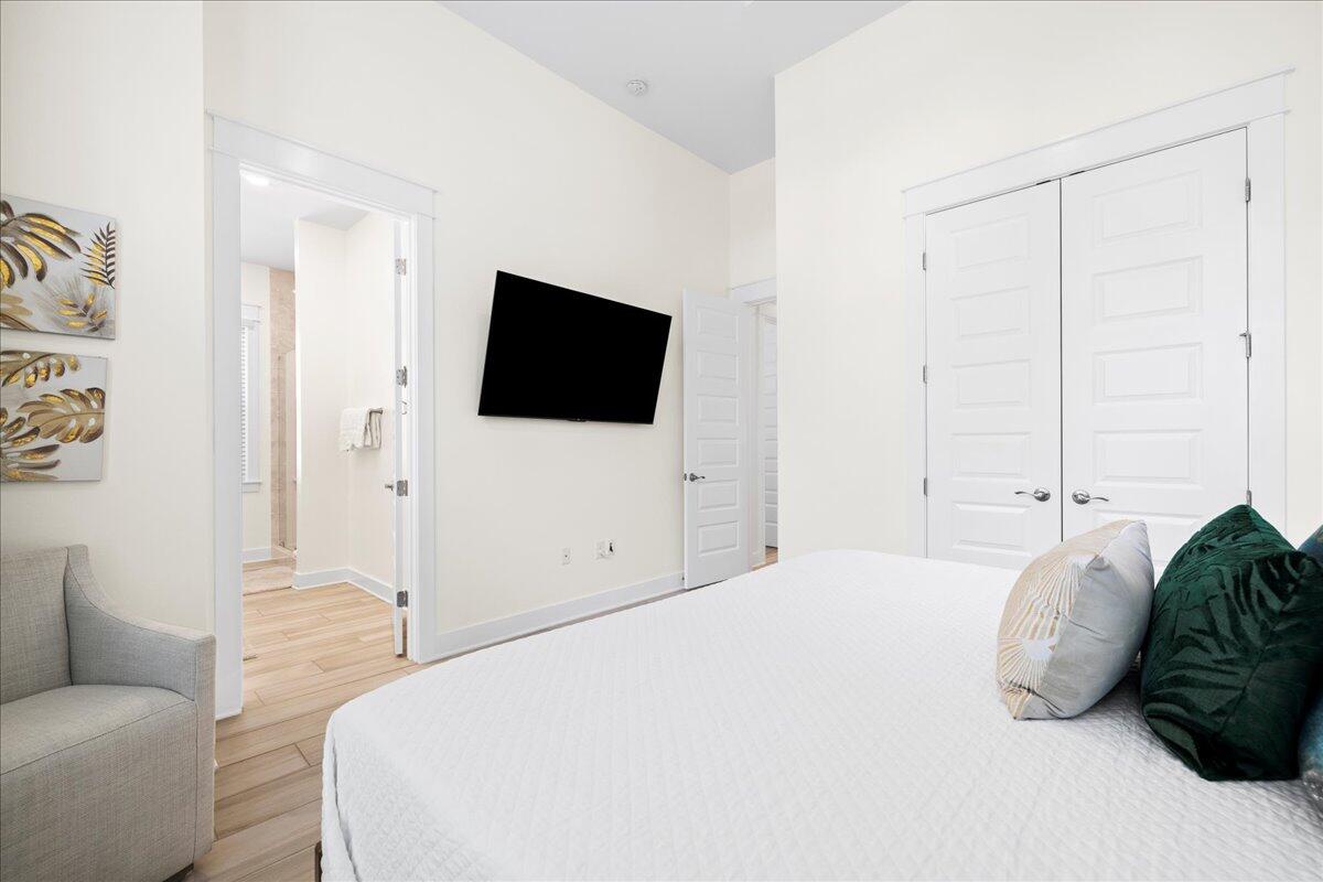 73 Dune Comet Lane, Unit B Inlet Beach, FL 32461 - Photo 8 of 25 a bedroom with a bed a television and a couch