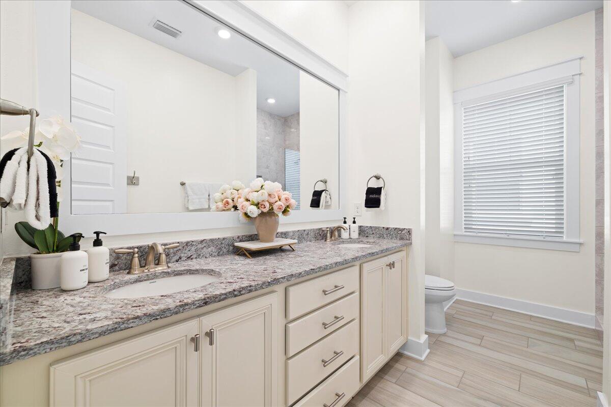 73 Dune Comet Lane, Unit B Inlet Beach, FL 32461 - Photo 9 of 25 a bathroom with a granite countertop double vanity sink and mirror