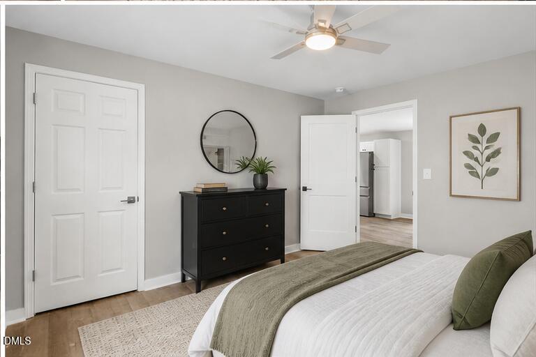 509 Sparella Street Durham, NC 27703 - Photo 17 of 30 a bedroom with a bed and a chandelier