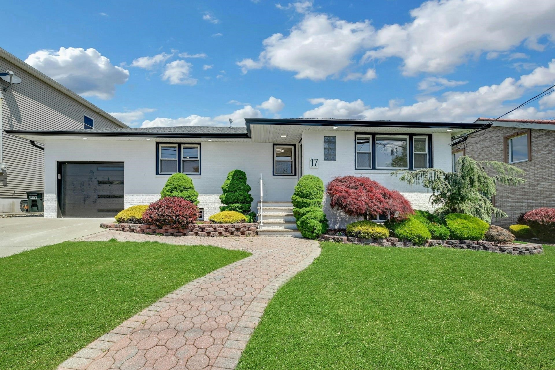 17 Arn Terrace Secaucus, NJ 07094 - Photo 1 of 34 a front view of a house with a garden and plants