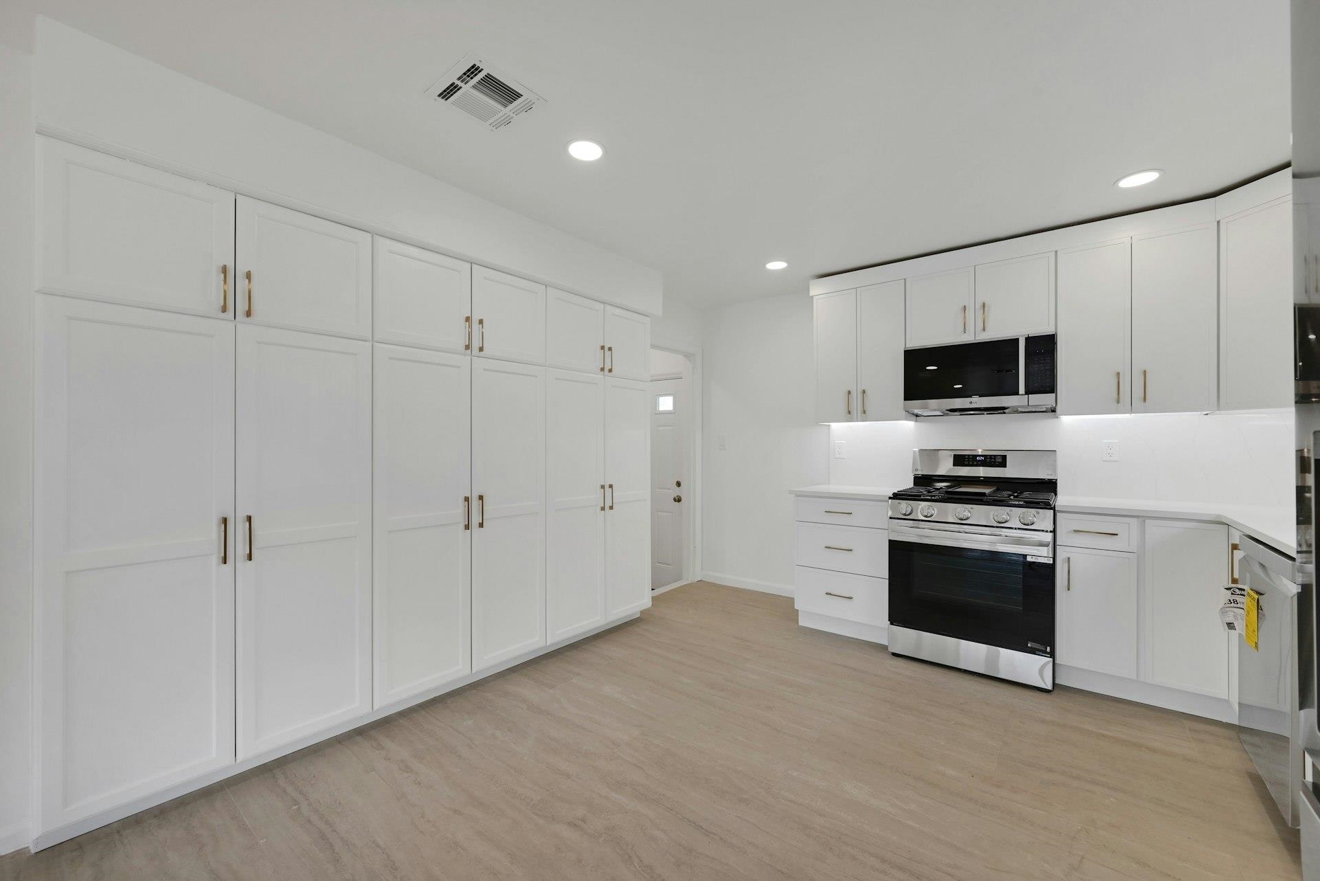 17 Arn Terrace Secaucus, NJ 07094 - Photo 11 of 34 a kitchen with granite countertop a stove a sink and a refrigerator