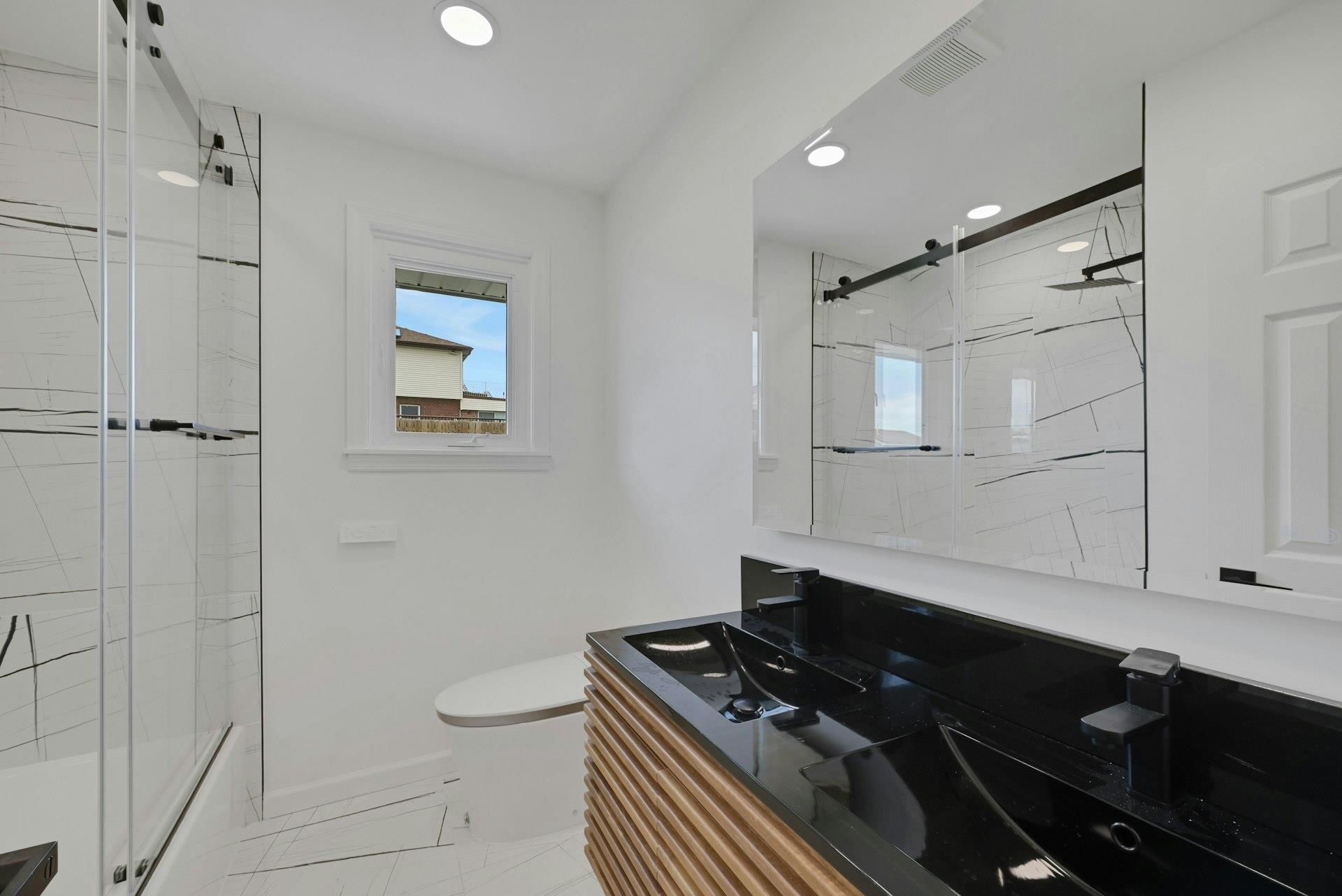 17 Arn Terrace Secaucus, NJ 07094 - Photo 14 of 34 a bathroom with a granite countertop sink a toilet a mirror and shower