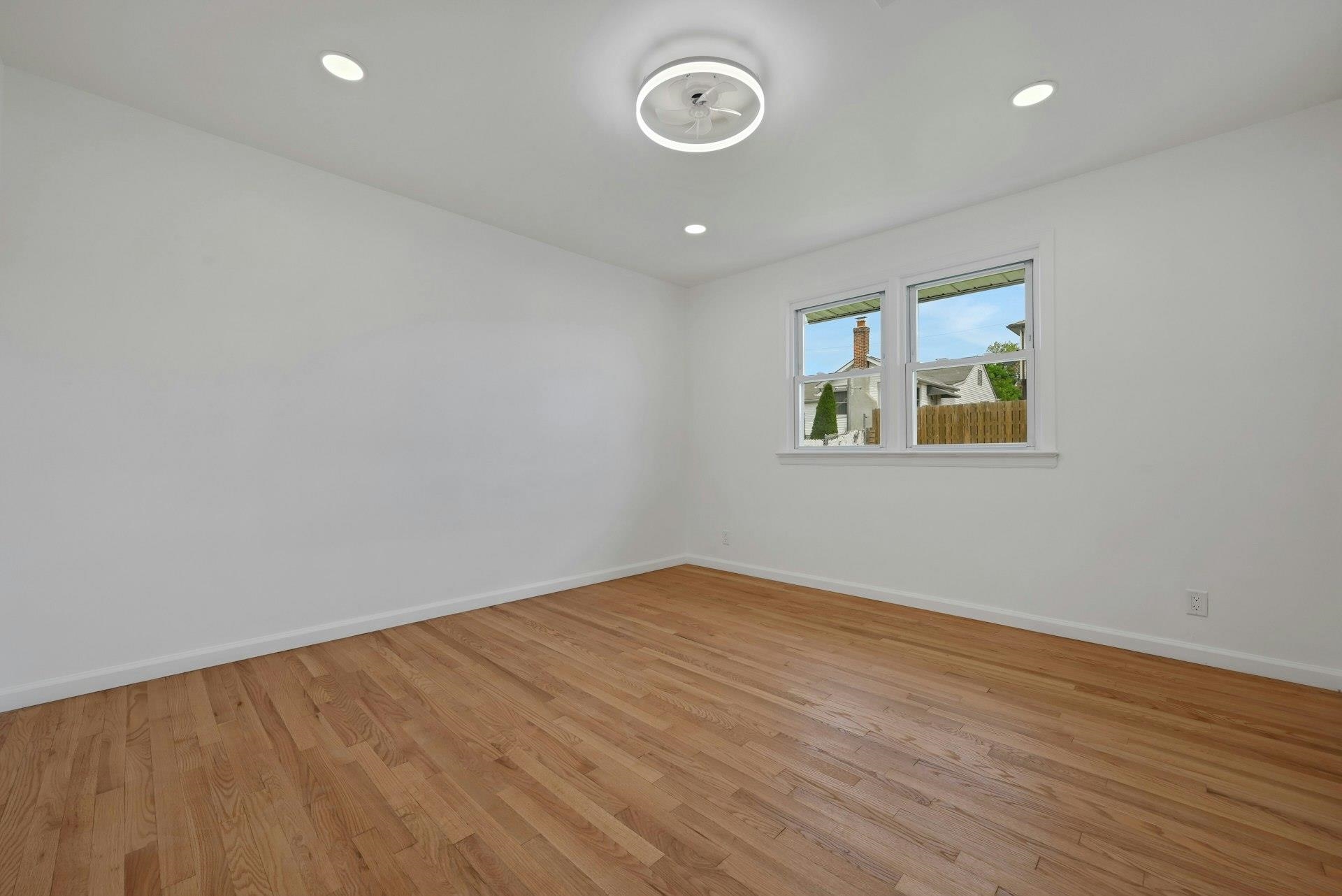 17 Arn Terrace Secaucus, NJ 07094 - Photo 16 of 34 an empty room with wooden floor and windows