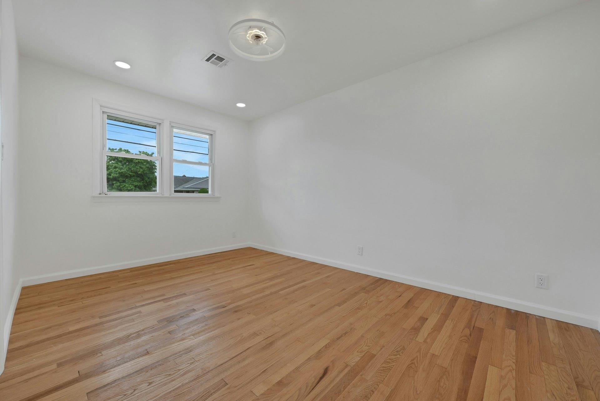 17 Arn Terrace Secaucus, NJ 07094 - Photo 18 of 34 an empty room with wooden floor and windows