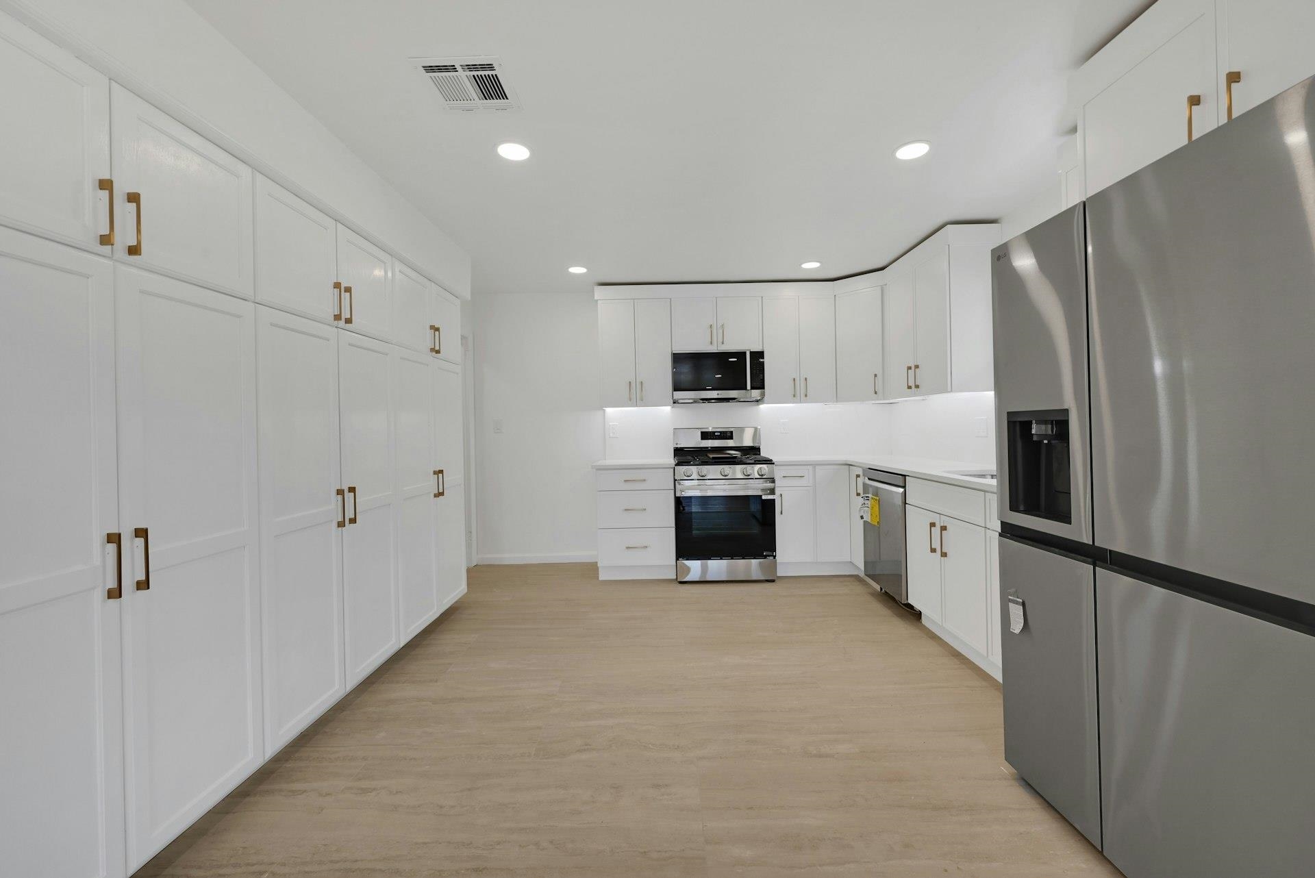 17 Arn Terrace Secaucus, NJ 07094 - Photo 22 of 34 a large kitchen with white cabinets and stainless steel appliances