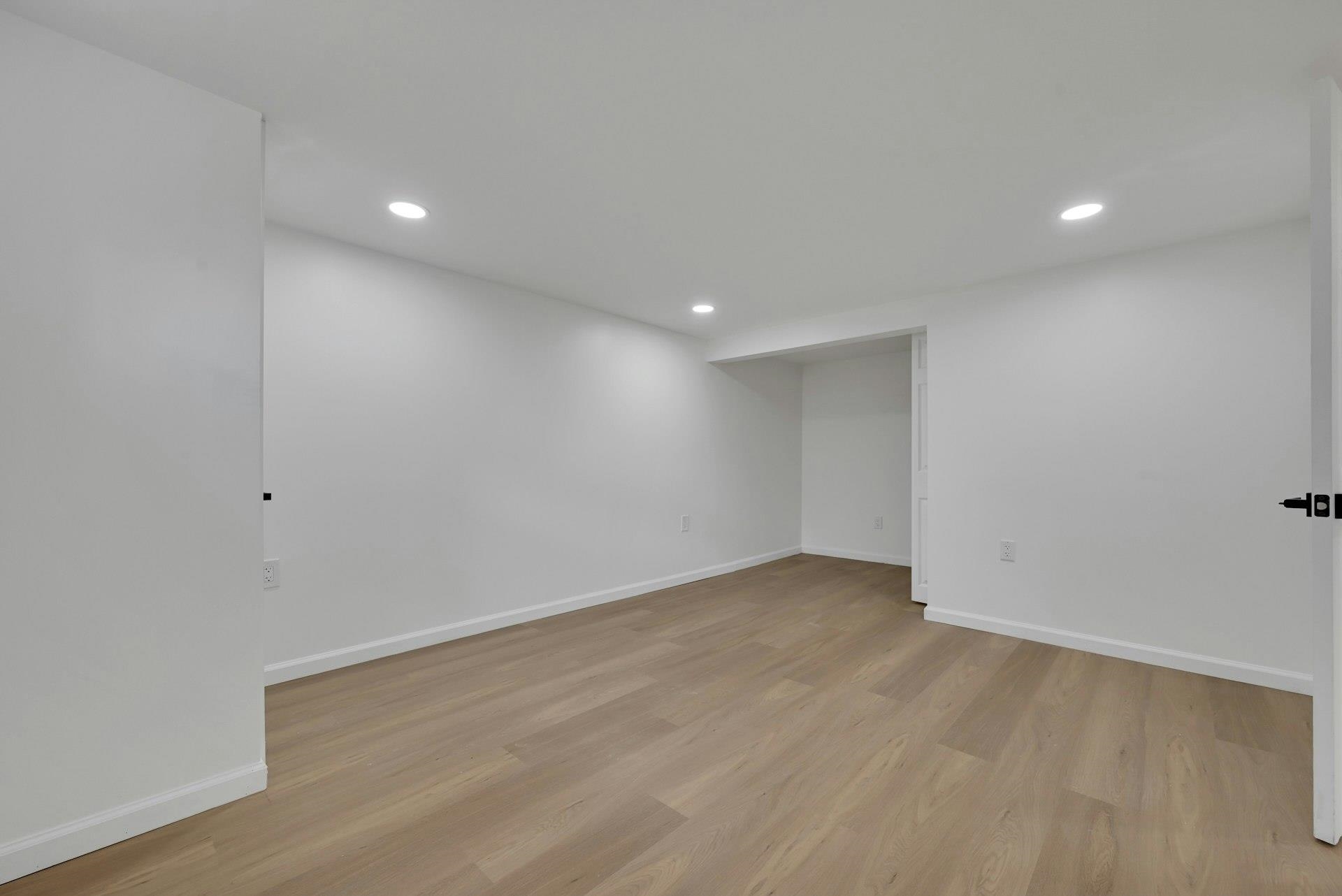 17 Arn Terrace Secaucus, NJ 07094 - Photo 30 of 34 an empty room with wooden floor and windows