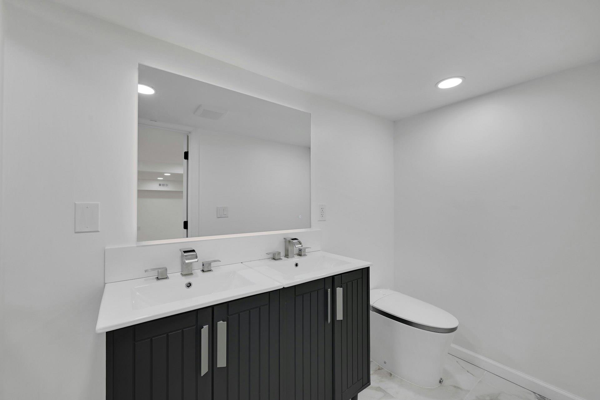 17 Arn Terrace Secaucus, NJ 07094 - Photo 33 of 34 a bathroom with a sink a toilet and a mirror