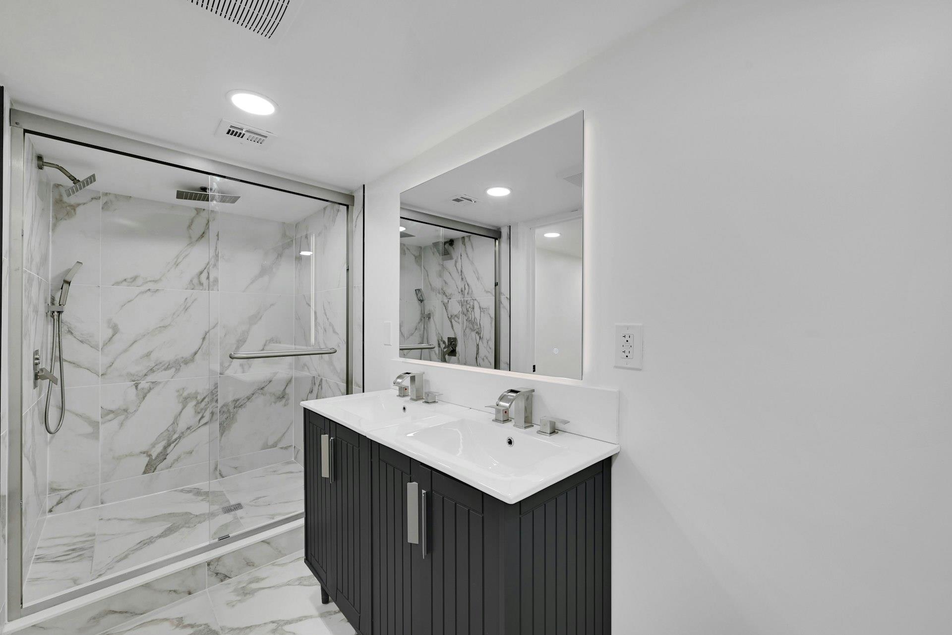 17 Arn Terrace Secaucus, NJ 07094 - Photo 34 of 34 a bathroom with a sink mirror and a shower
