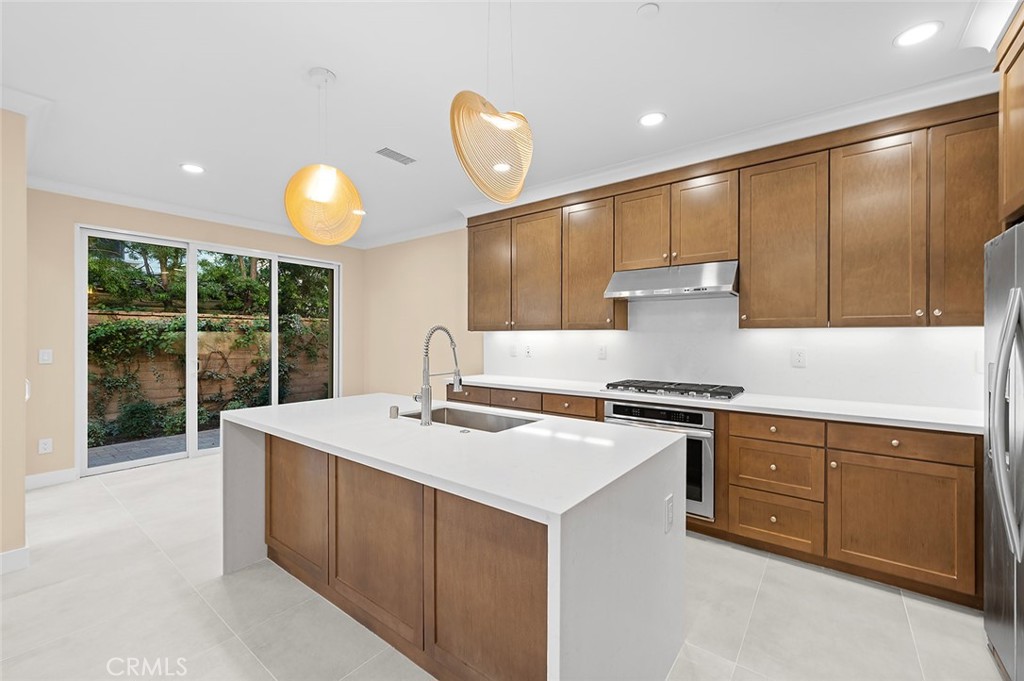 143 Rodeo Irvine, CA 92602 - Photo 2 of 37 a kitchen with a stove a sink and a refrigerator