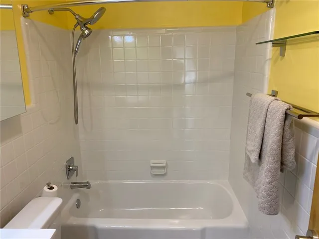 a bathroom with a bath tub with a shower