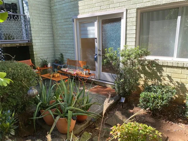 a view of a chairs and table in a patio