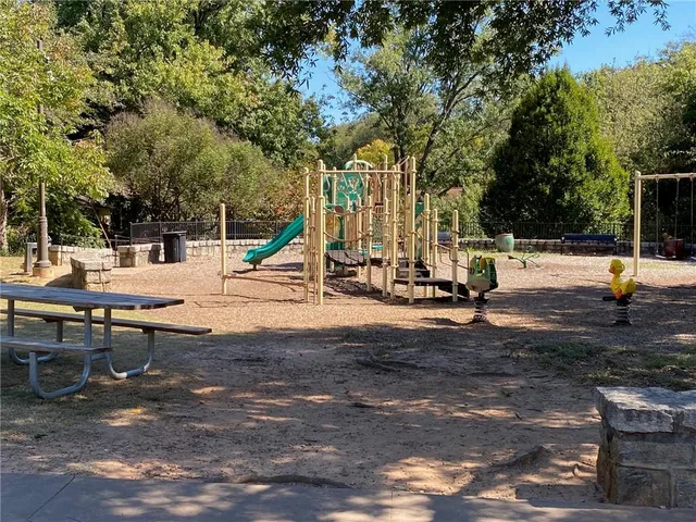 a view of a park with swings and slides