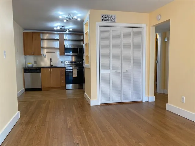 a view of a kitchen with a sink and a stove top oven