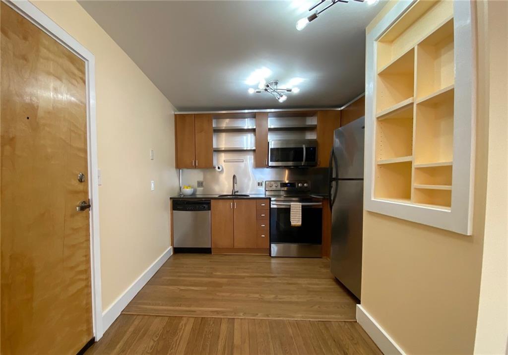 181 Powell Street Southeast, Unit 2 Atlanta, GA 30316 - Photo 10 of 47 a kitchen with a refrigerator and a stove top oven
