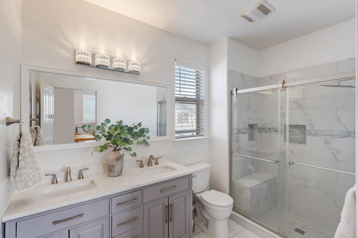 8850 Morey Way Gilroy, CA 95020 - Photo 19 of 34 a bathroom with a shower sink vanity mirror and toilet