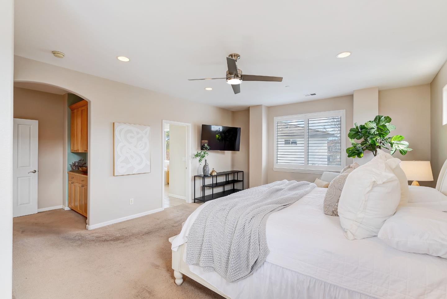 8850 Morey Way Gilroy, CA 95020 - Photo 21 of 34 a bedroom with a large bed and a flat screen tv